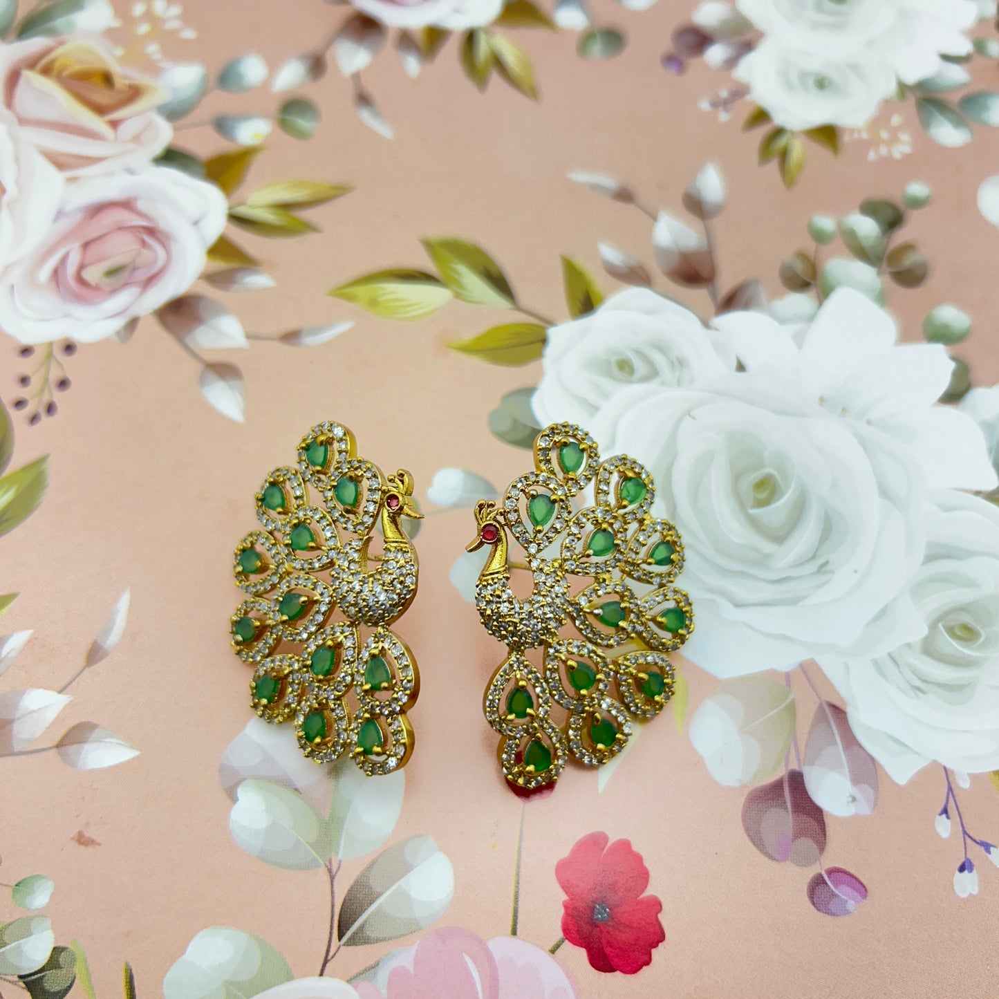 Peacock elegance statement stud - green stones