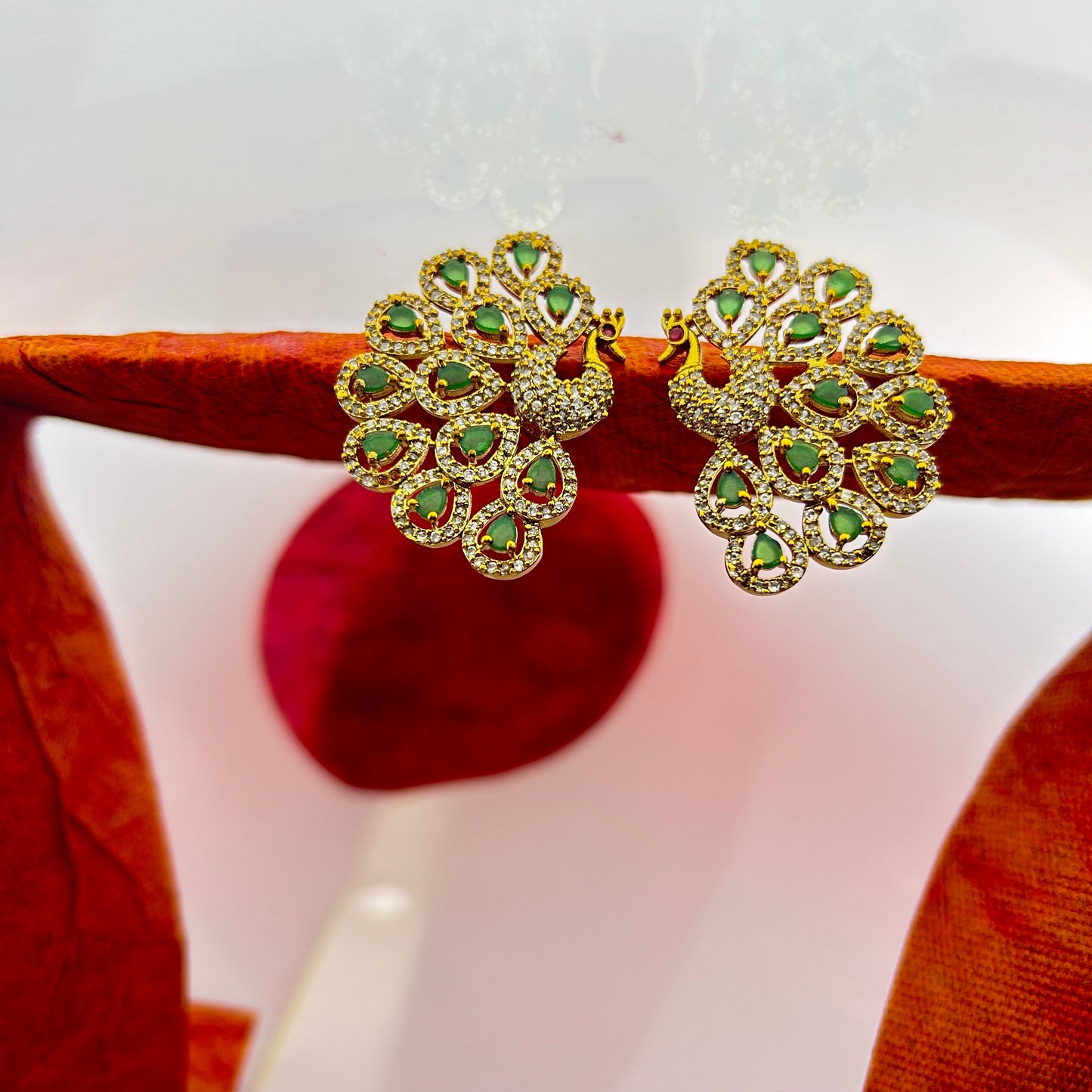 Peacock elegance statement stud - green stones