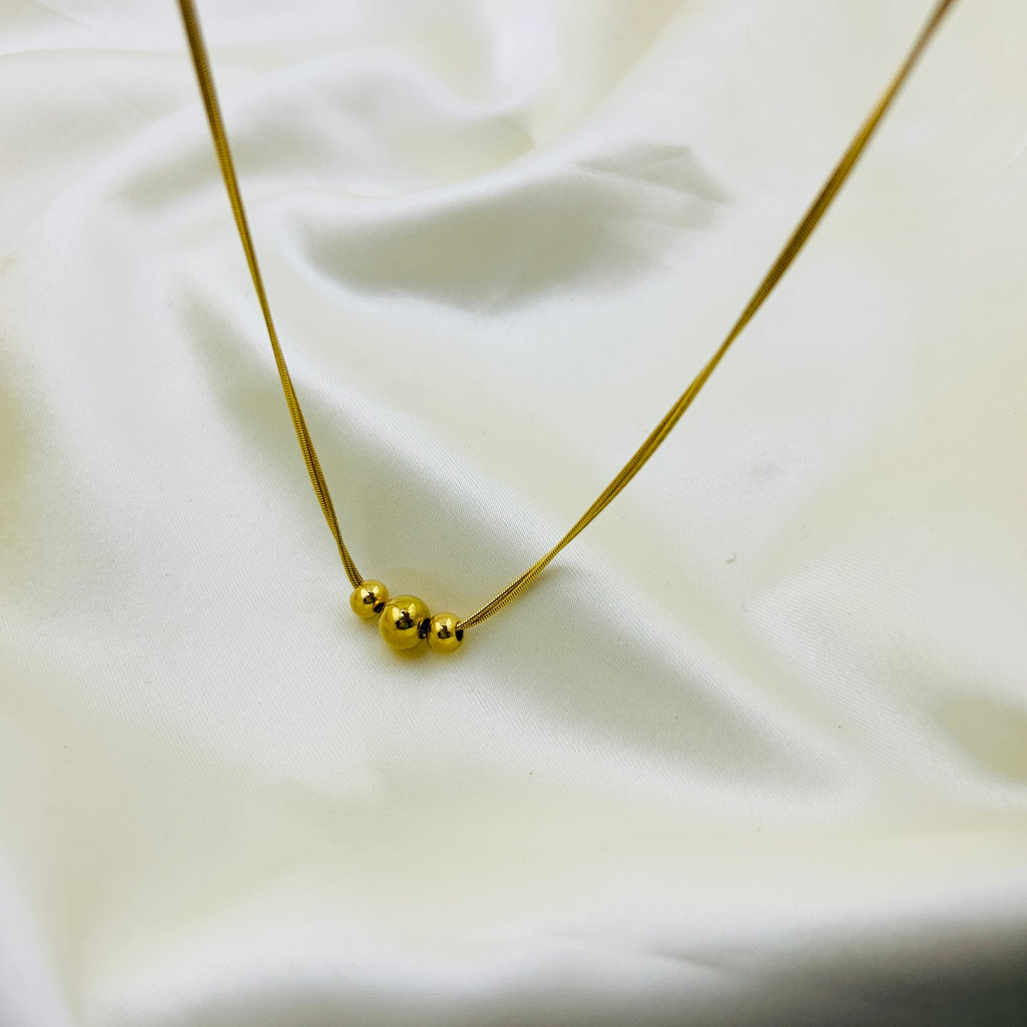 Three gold beaded two layer demifine necklace