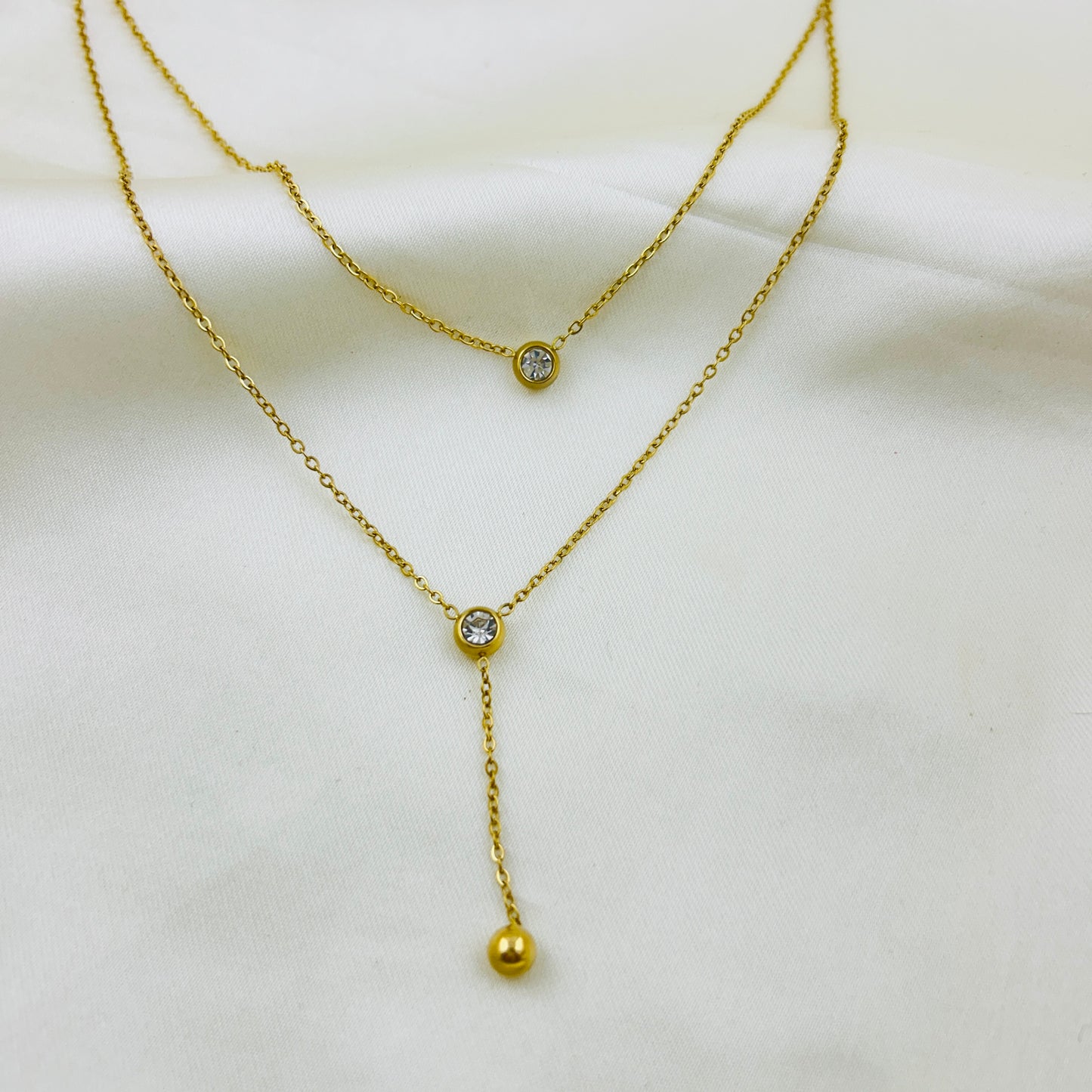 Two layered round stone with a gold drop demifine necklace