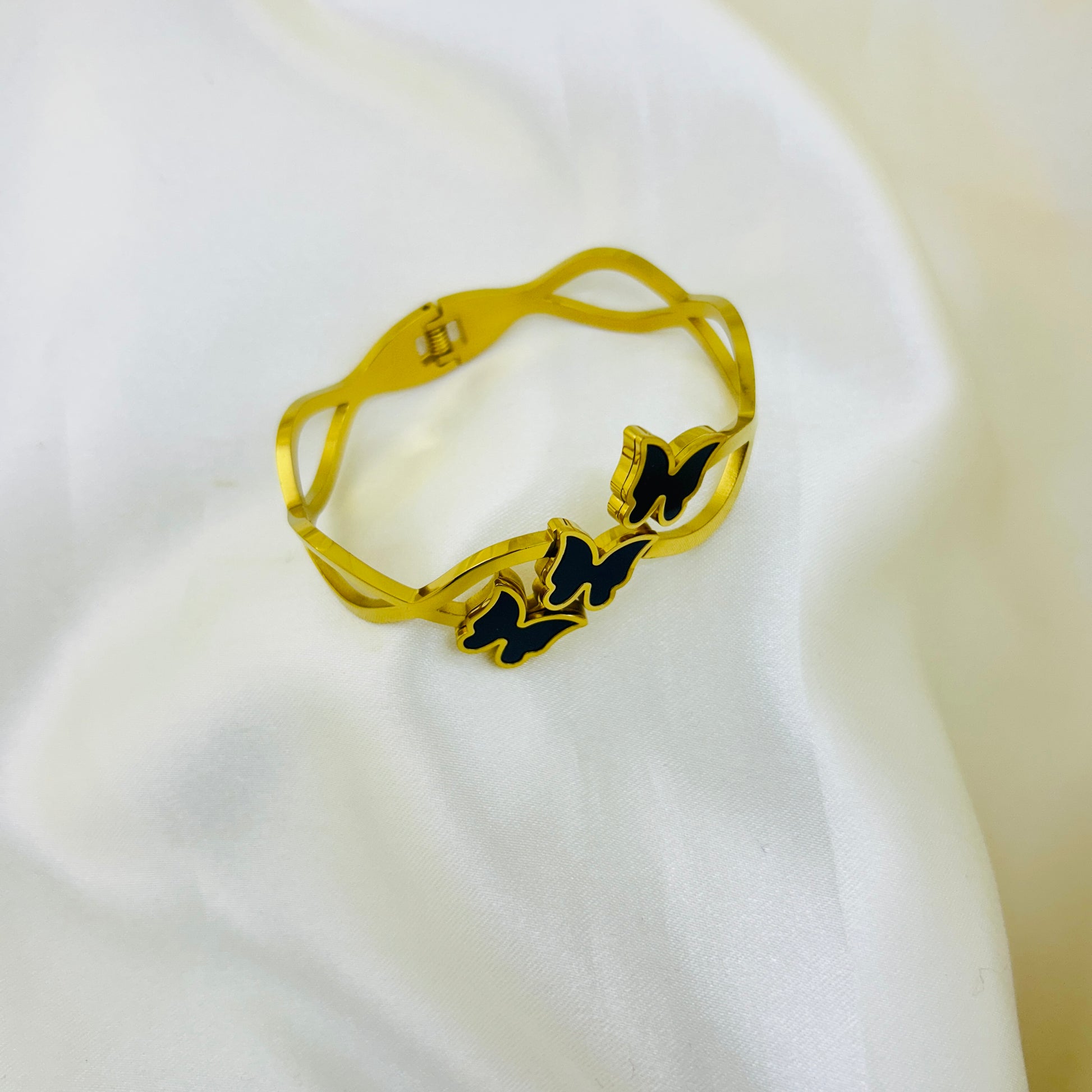 Close-up of butterfly cuff bracelet on white background