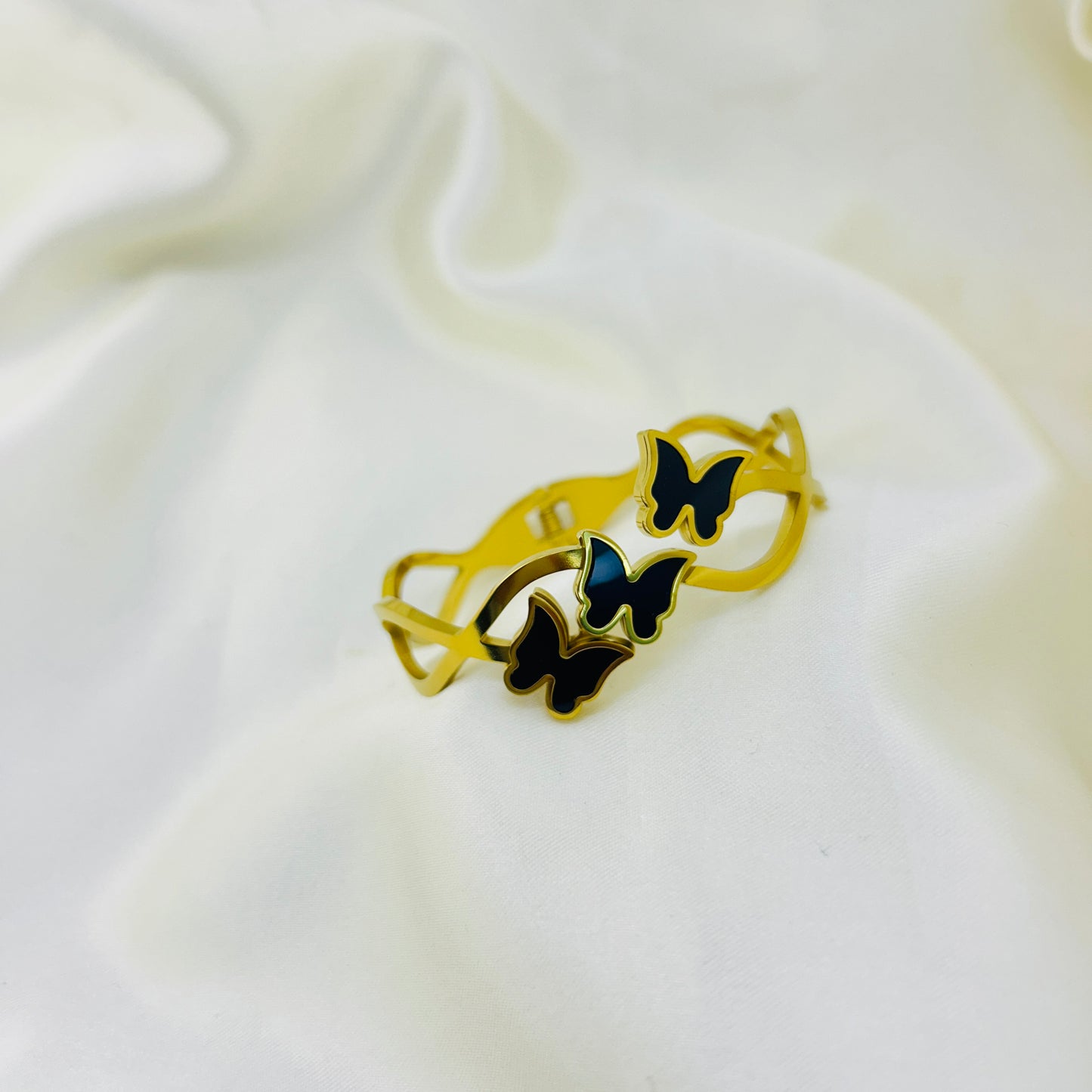 Infinity loop gold bracelet with enamel butterflies