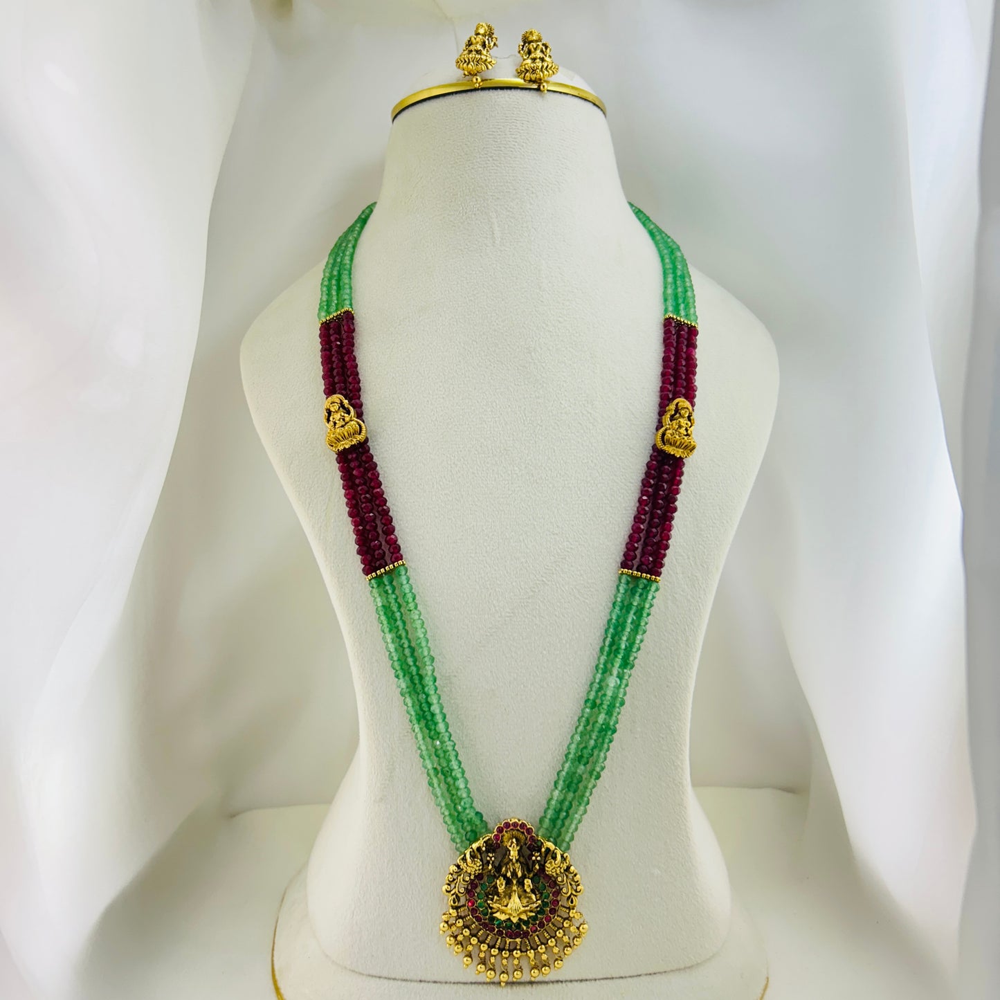 Long necklace with light green and pink semiprecious beads and Lakshmi pendants with earrings