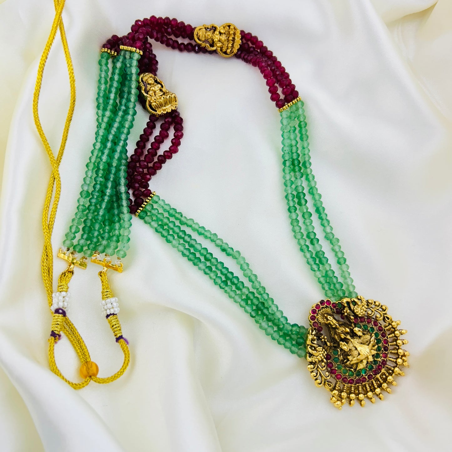 Long necklace with light green and pink semiprecious beads and Lakshmi pendants with earrings