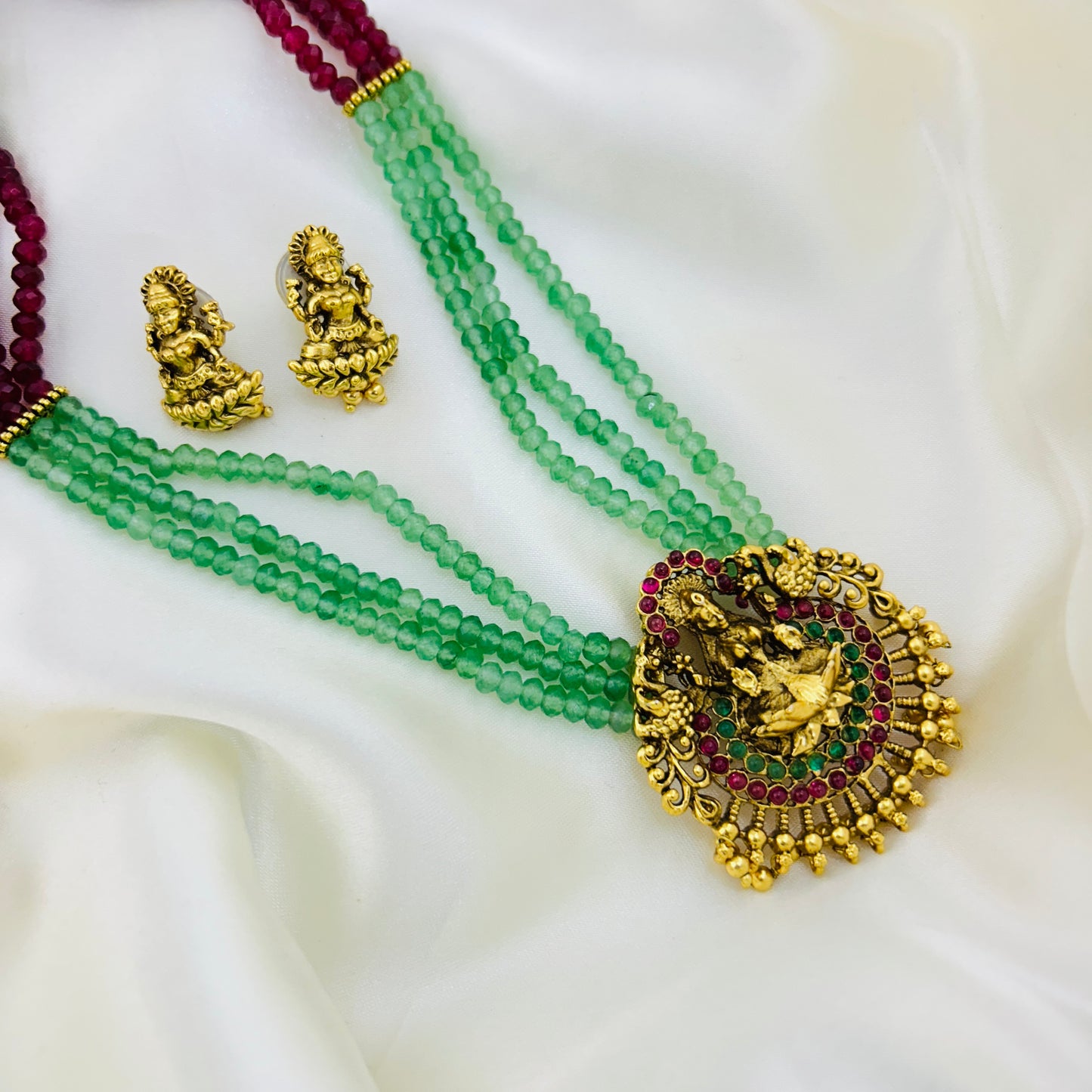 Long necklace with light green and pink semiprecious beads and Lakshmi pendants with earrings