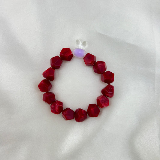 Red beaded bracelet with a contrast bunny bead