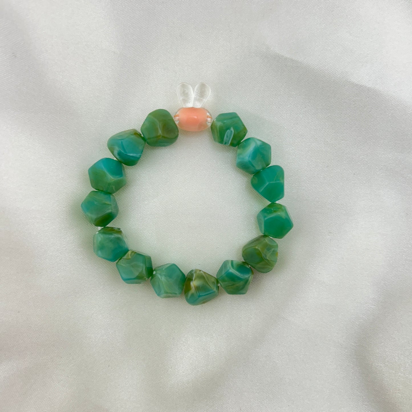 Green beaded bracelet with a contrast bunny bead