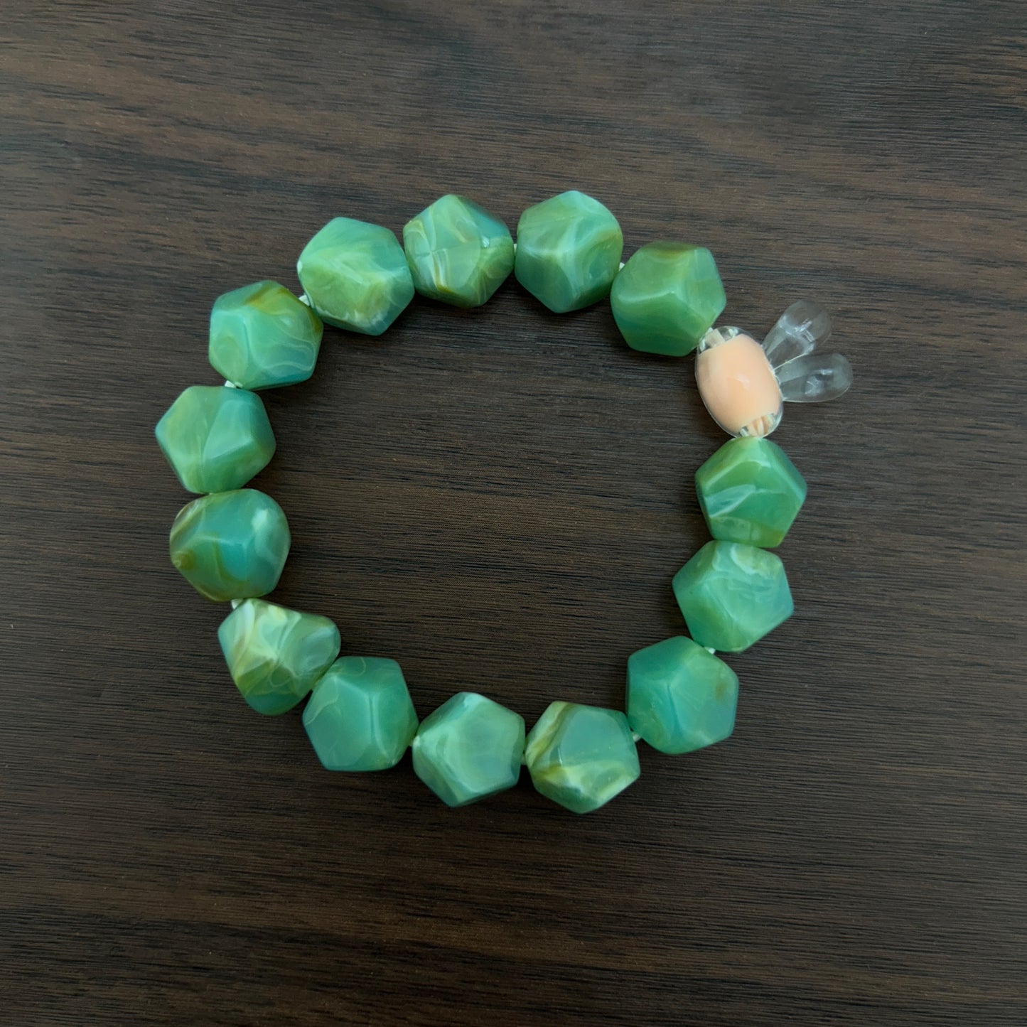 Green beaded bracelet with a contrast bunny bead