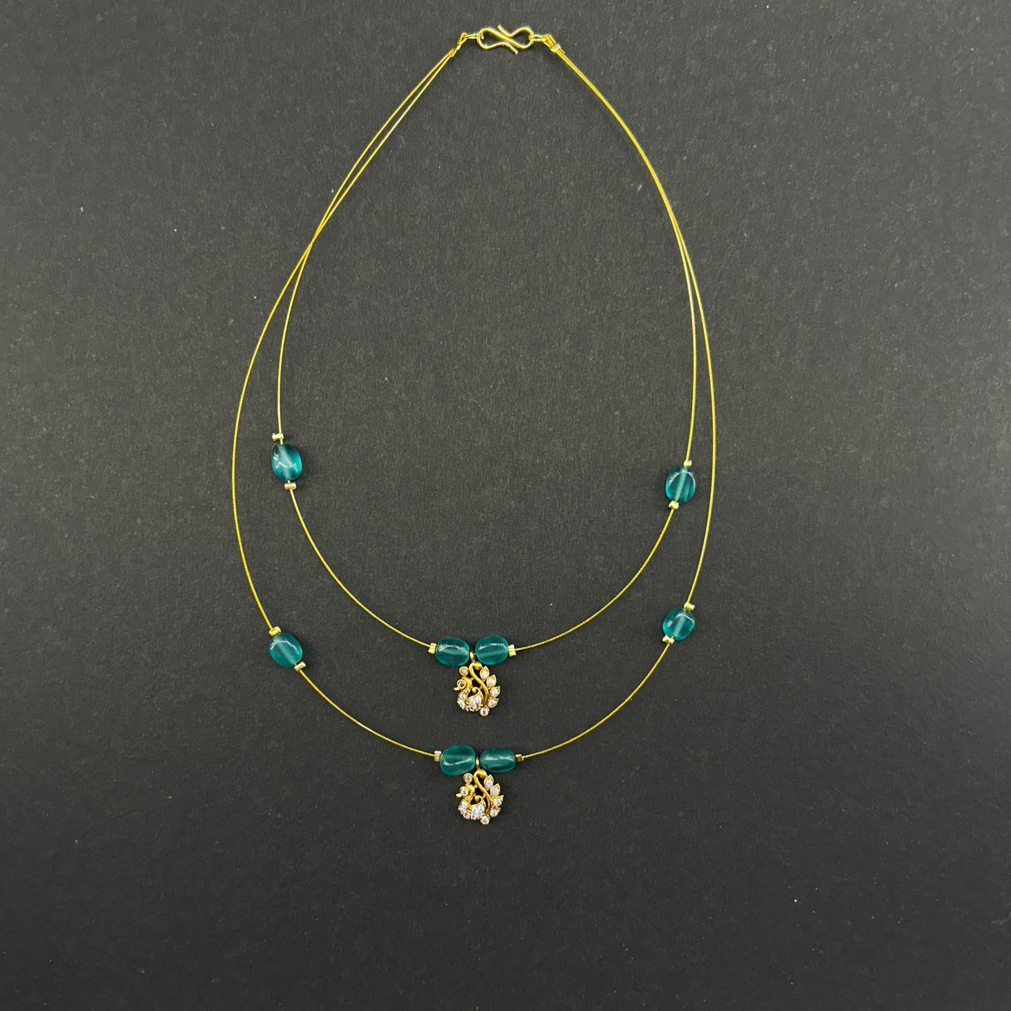 Two layered pacock green beaded invisible chain