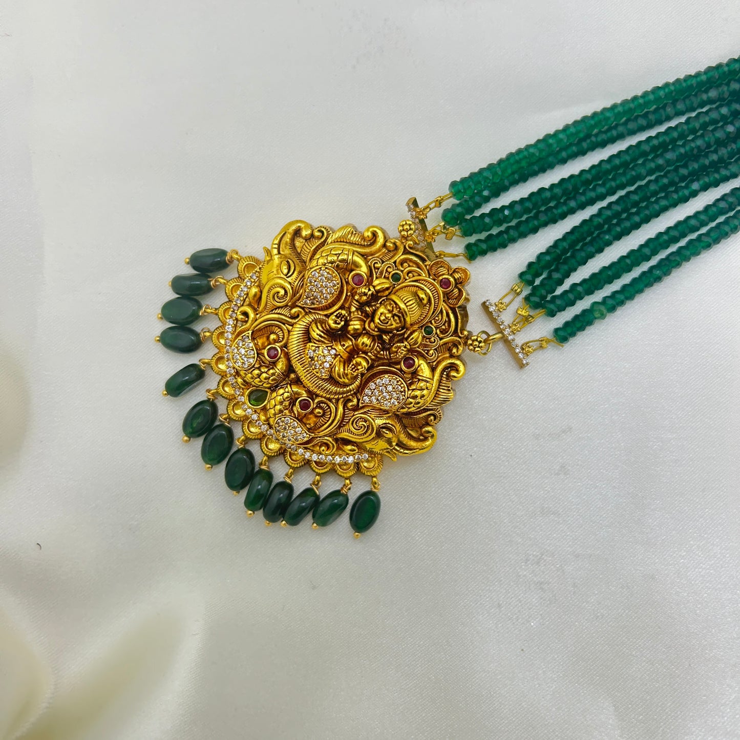 Long necklace with green semiprecious beads and Lakshmi pendants