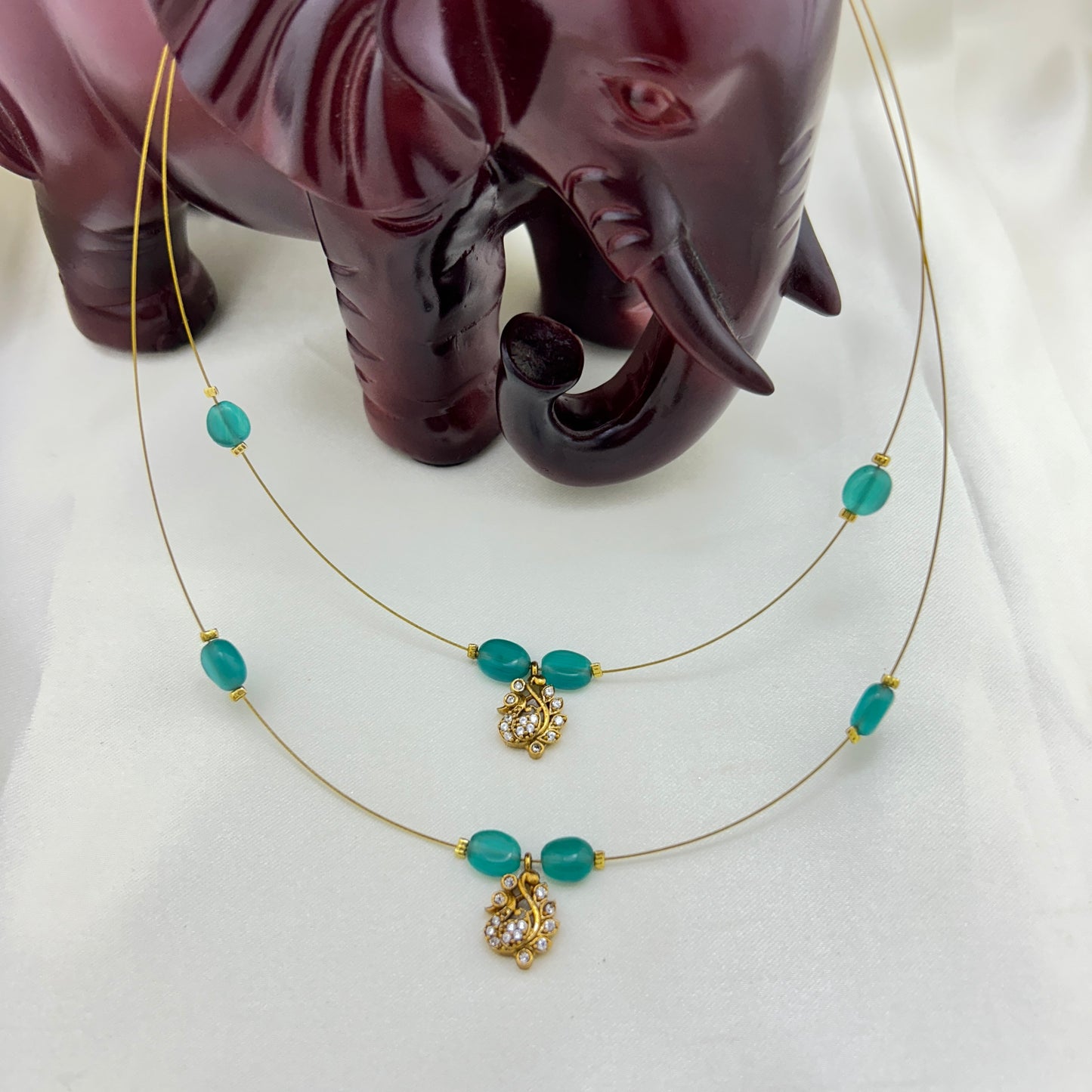Two layered pacock green beaded invisible chain