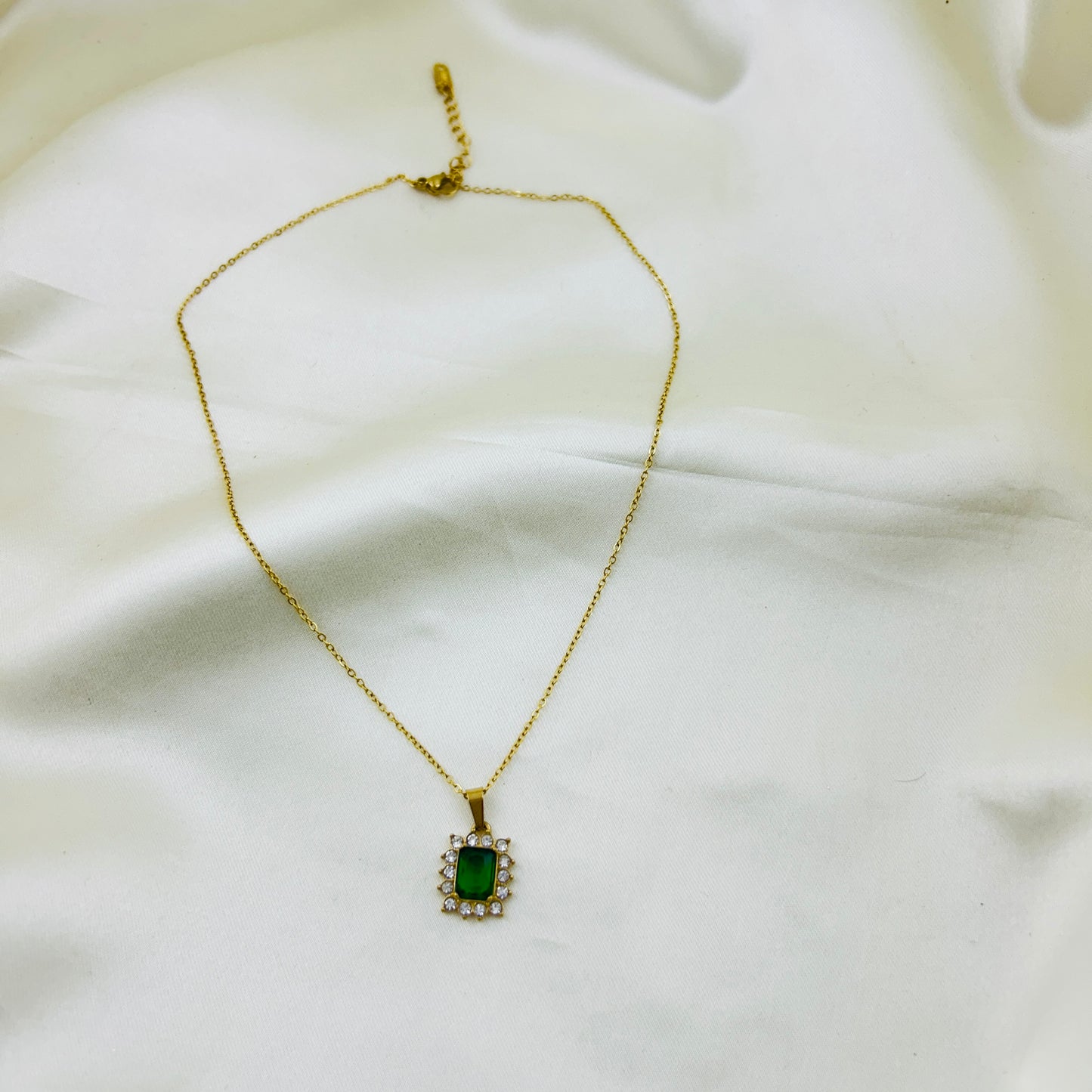 Emerald Green stone with AD around pendant in a thin chain demifine necklace