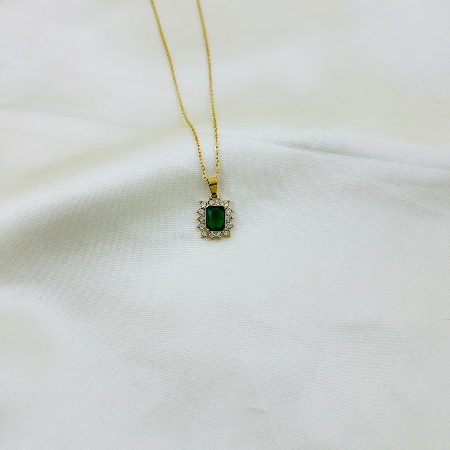 Emerald Green stone with AD around pendant in a thin chain demifine necklace