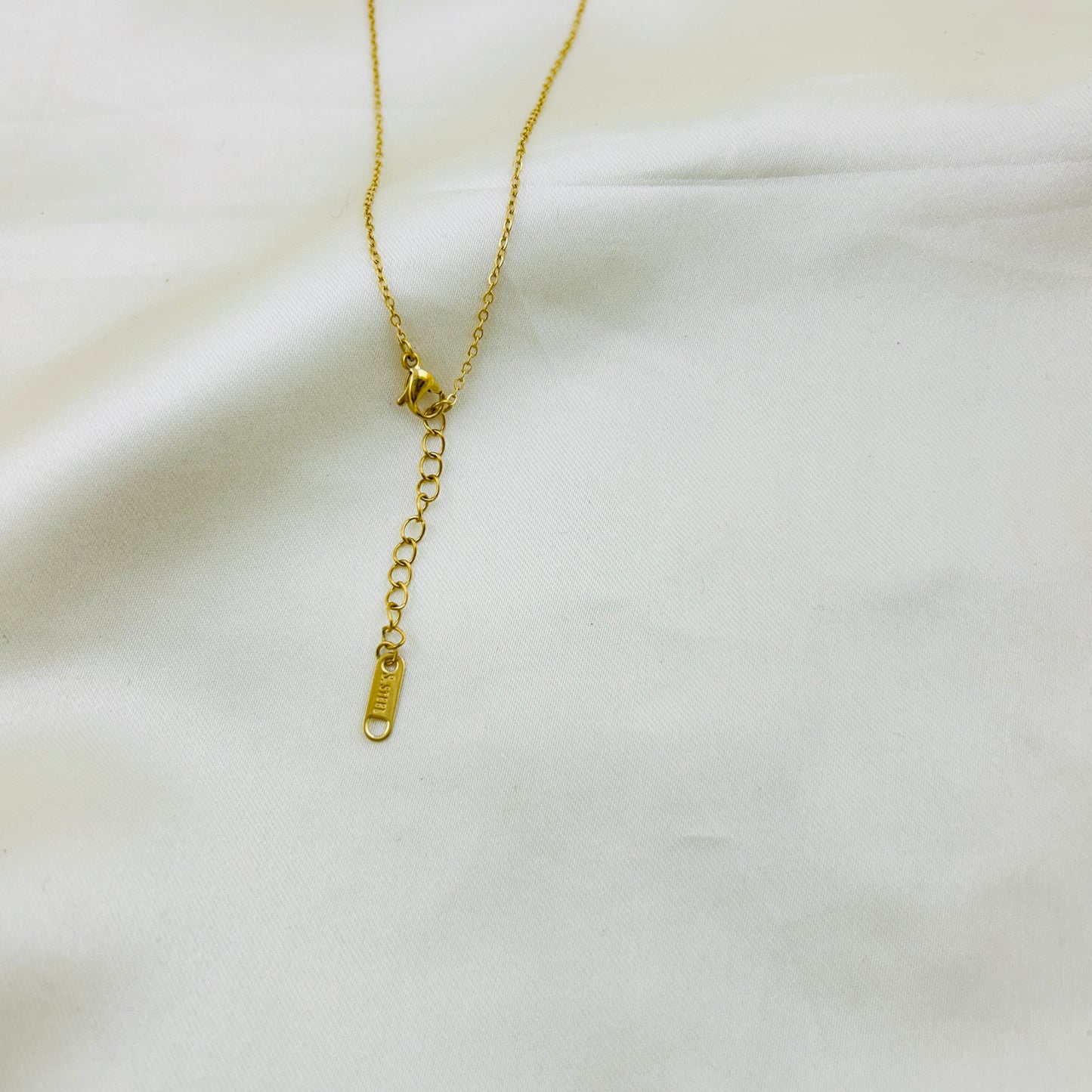 Emerald Green stone with AD around pendant in a thin chain demifine necklace