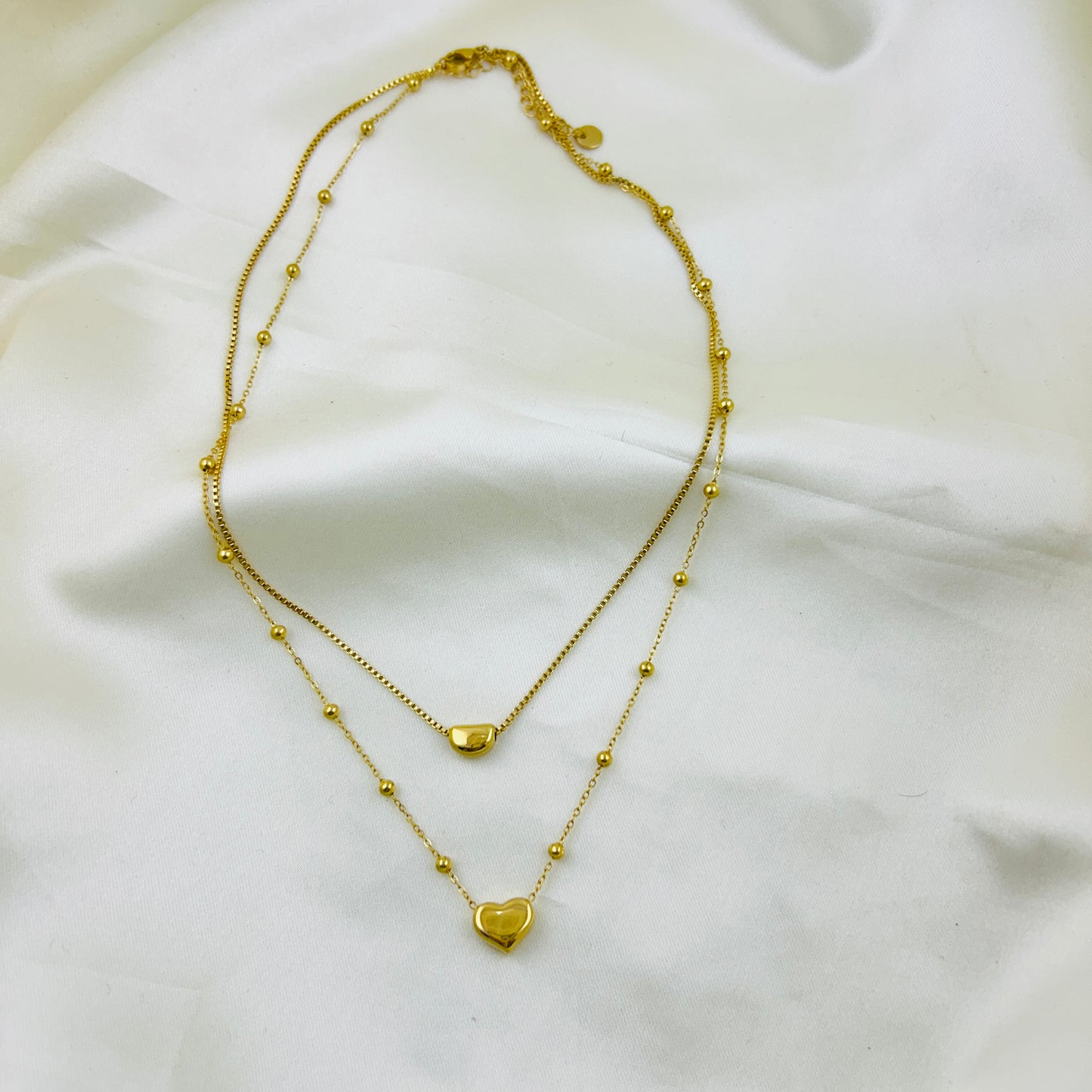 Heart pendant in a dotted chain and a crescent pendant in a thin chain two layer demifine necklace