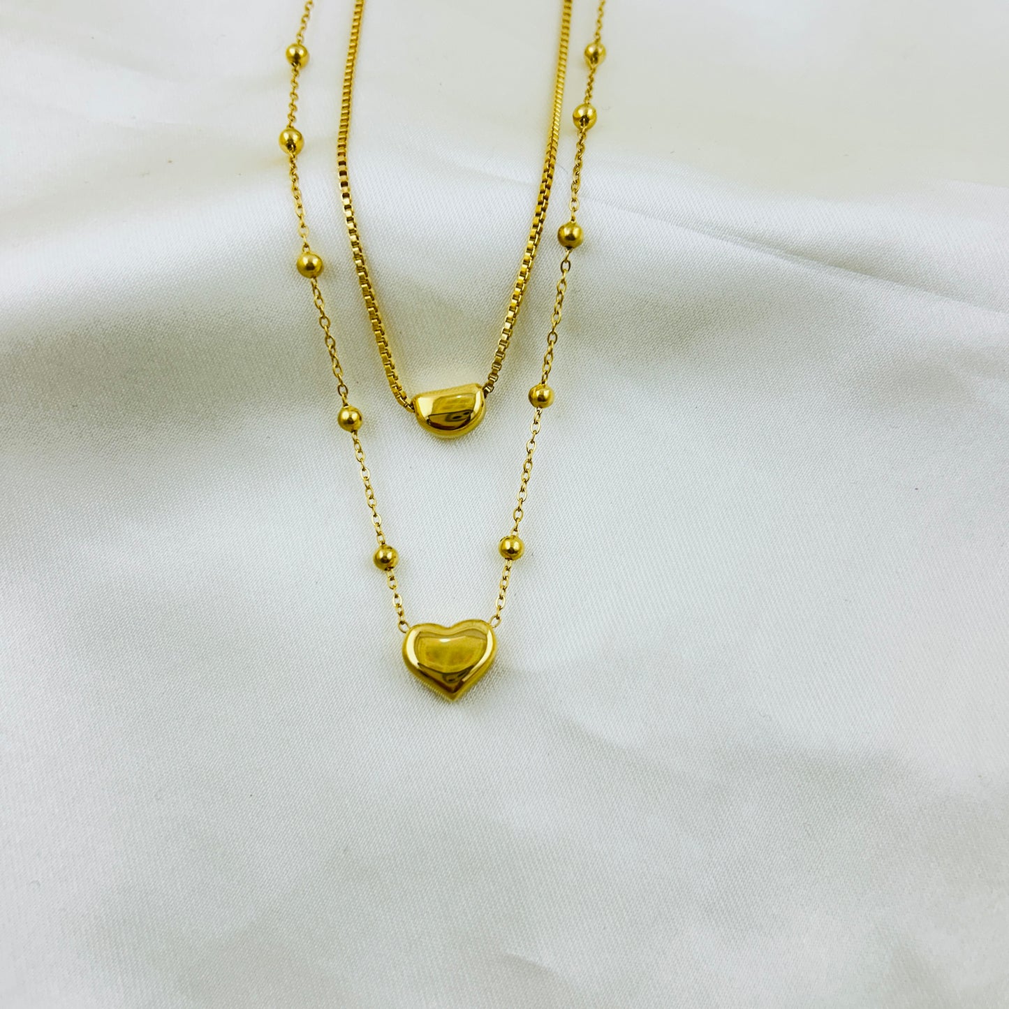 Heart pendant in a dotted chain and a crescent pendant in a thin chain two layer demifine necklace