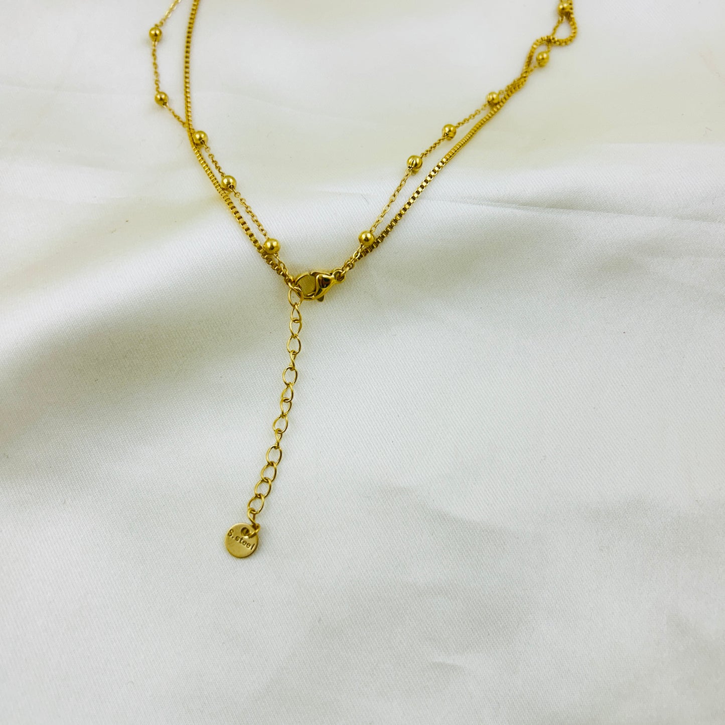 Heart pendant in a dotted chain and a crescent pendant in a thin chain two layer demifine necklace