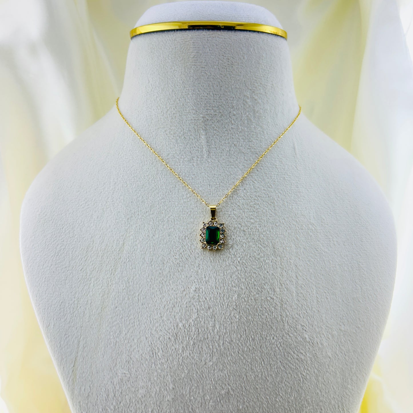 Emerald Green stone with AD around pendant in a thin chain demifine necklace