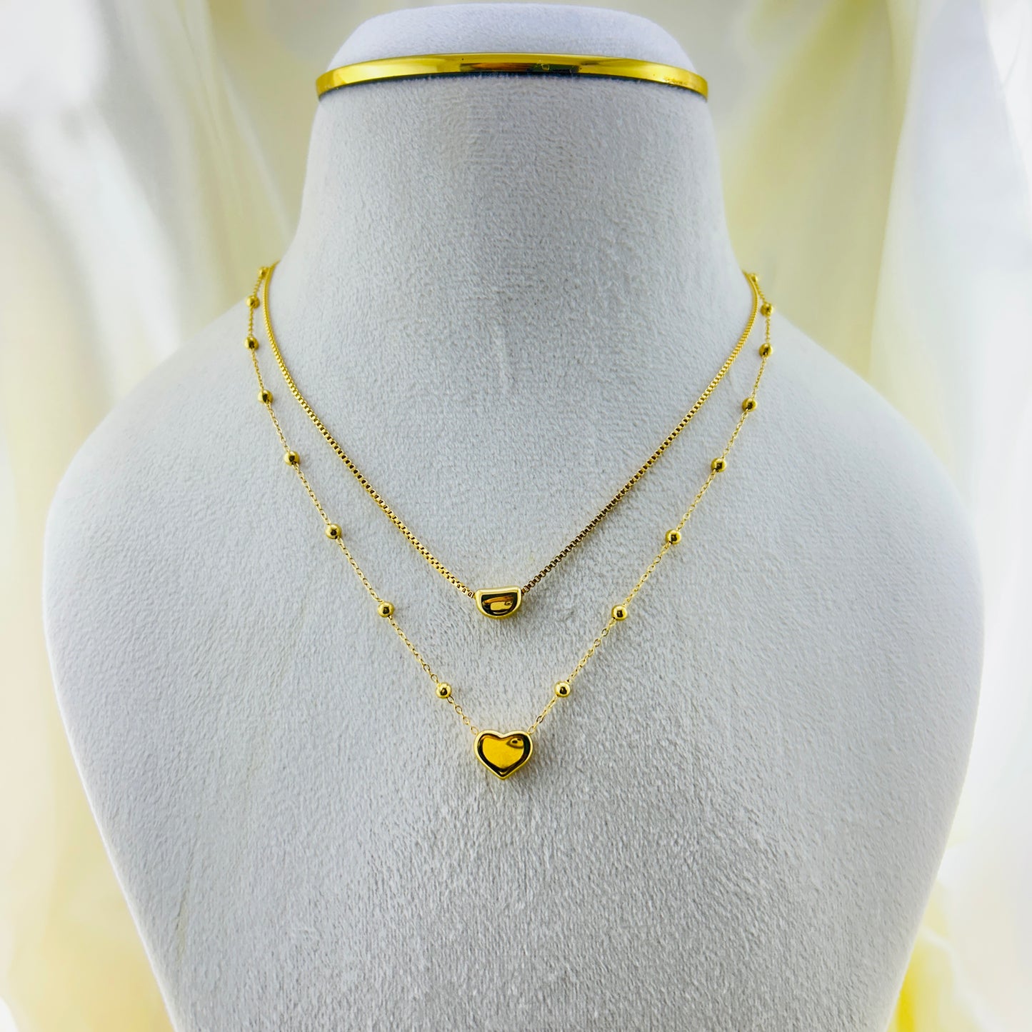 Heart pendant in a dotted chain and a crescent pendant in a thin chain two layer demifine necklace