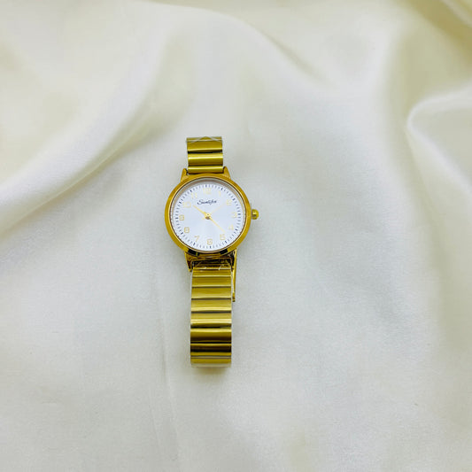 Gold wristwatch on a white fabric background