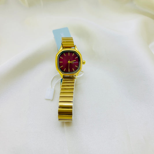 Gold watch with a magenta pink face on a white background